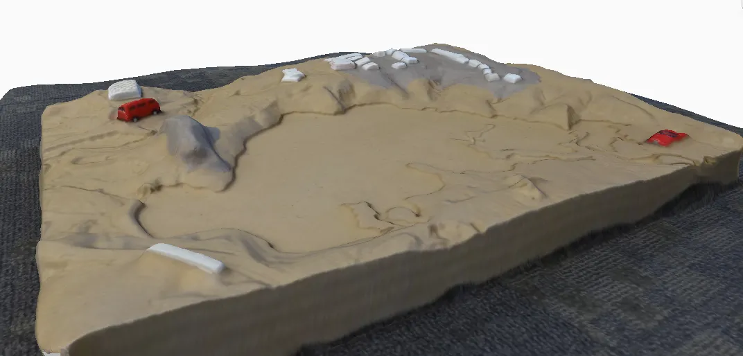 Textured 3D model of a sand terrain model with roads and buildings, reconstructed from photographs